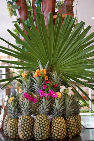 Still life from the pineapples decorated red, yellow and white with flowersの写真素材