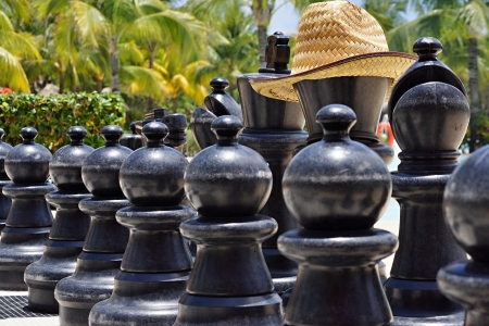 Big black figures for game in chess on a beach during restの写真素材