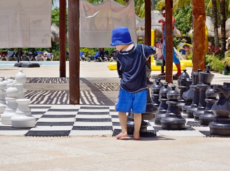 The boy plays big chessmen in the sea resortのeditorial素材