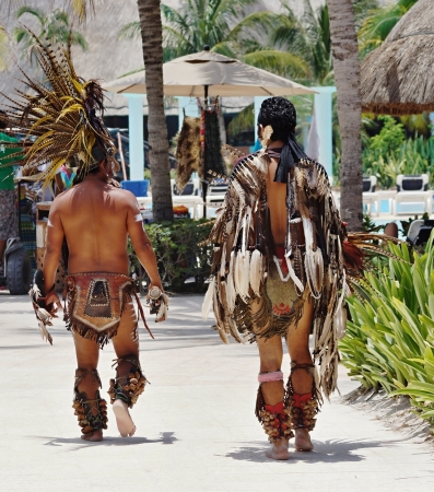 Two suntanned men in suits of Indians walk on the sea resortのeditorial素材