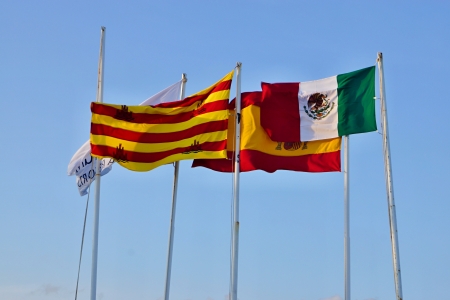 The Mexican flags develop a wind against the blue skyの写真素材