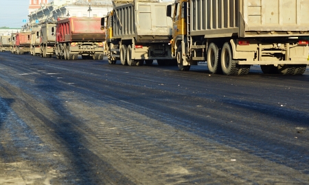 Cars - dump trucks on a construction of roads in the cityの写真素材