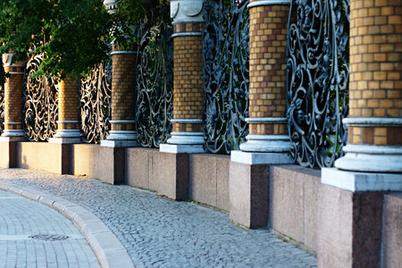 Ancient fencing of park from stone columns and the forged iron sectionsの写真素材