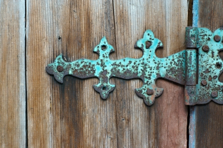 Fragment of an old wooden door, old rusty hinged loops, abstraction for a backgroundの写真素材