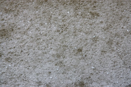 Abstract black background from texture of white foam on a surface of soap waterの写真素材
