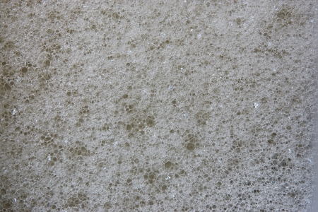 Abstract black background from texture of white foam on a surface of soap waterの写真素材
