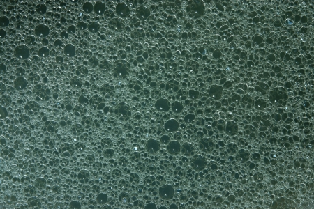 Abstract gray-blue background from texture of white foam on a surface of soap waterの写真素材