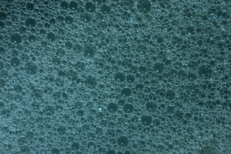 Abstract gray-blue background from texture of white foam on a surface of soap waterの写真素材