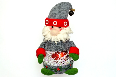 The Christmas toy of Santa Claus for the festive fir-tree, isolated on a white background, attentively and cheerfully looksの写真素材