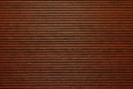 Texture of a surface from bamboo sticks for an abstract background of brown colorの写真素材