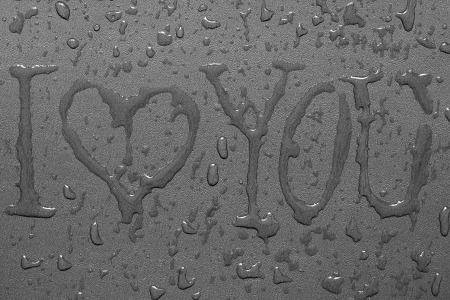 Inscription "I love you" and water drops on a gray backgroundの写真素材