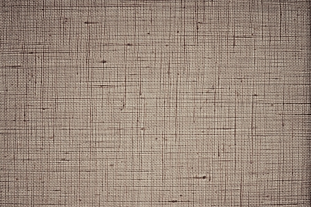 Texture of dense brown fabric closeup against bright light of a white lamp for abstract backgrounds and wallpaperの写真素材