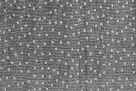 texture of seamy side of fabric with white peas on a gray backgroundの写真素材
