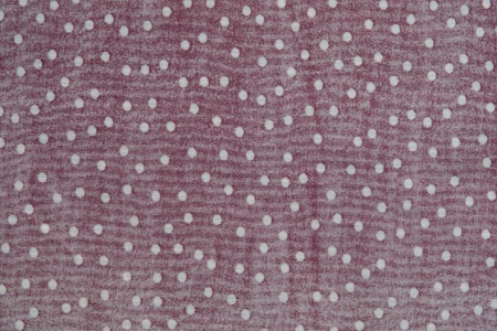 texture of seamy side of fabric with white peas on a red backgroundの写真素材