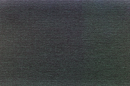 the abstract background is executed from granular texture on a black green surfaceの写真素材