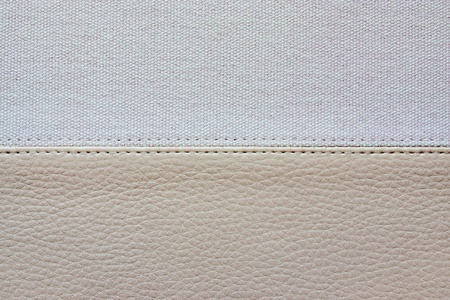 abstract background from a combination of textures of an imitation leather and rough fabricの写真素材