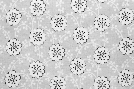 the textured background of cotton fabric of gray color with a pattern from abstract floretsの写真素材