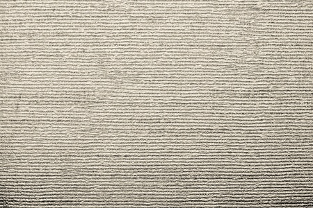horizontal corrugated texture of paper wallpaper with an imprinted vinyl surface for abstract backgrounds of beige colorの写真素材