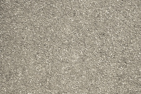 rough granular texture of an old asphalt surface for abstract beige backgrounds with impregnationsの写真素材