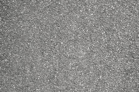 rough granular texture of an old asphalt surface for abstract gray backgrounds with impregnationsの写真素材