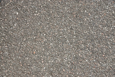 rough granular texture of an old asphalt surface for abstract backgrounds with motley impregnationsの写真素材