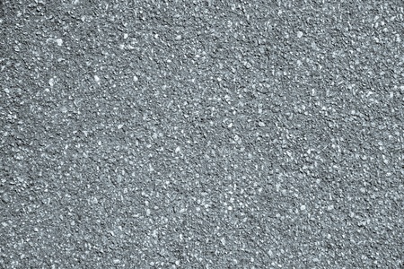 rough granular texture of an old asphalt surface for abstract silvery backgrounds with impregnationsの写真素材