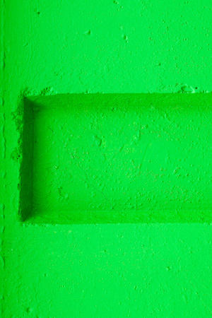 abstract relief of a hollow and ledges on a concrete wall for textural backgrounds of bright green colorの写真素材