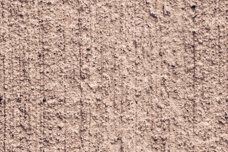 texture of a rough rough concrete wall with cracks for abstract backgrounds of terracotta brown colorの写真素材