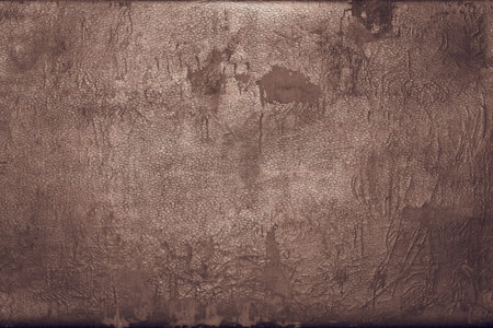 the abstract textured background of rough shabby and frayed old leather of dark copper color with...