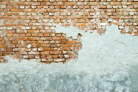 ancient brick wall with the partial destroyed old plasterの写真素材