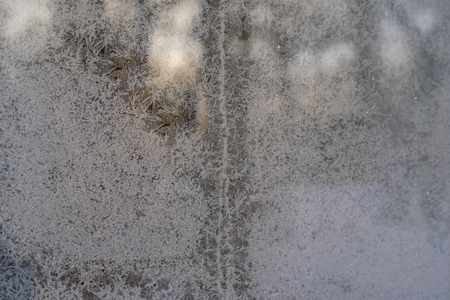 winter ice hoarfrost on the frozen glassの写真素材