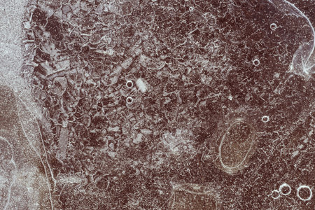 abstract surface of ice of coffee color with bubbles and with scratchesの写真素材