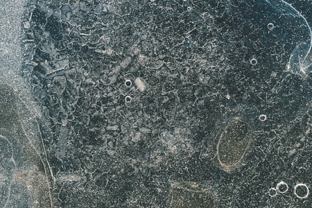 abstract surface of ice of dirty-green color with bubbles and with scratchesの写真素材