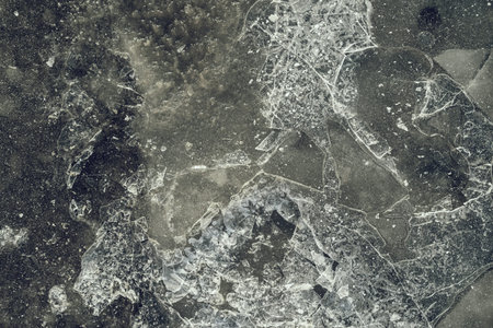 gray-green color texture of a glossy surface of ice with cracks and with splinters for abstract backgroundsの写真素材