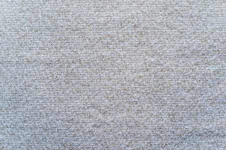 abstract textile texture of felt fabric with tinted stains of silvery beige color for empty and pure backgroundsの写真素材
