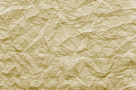 abstract crumpled texture of linen fabric of bright sand color with gentle an embroidery of flowers on a surface for empty and pure backgroundsの写真素材