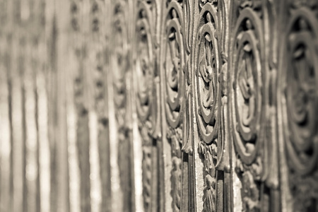 fragment of an ancient pig-iron fence with the abstract forged pattern of beige colorの写真素材