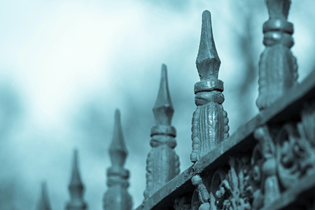 ancient peak of a tip of blue color of an old iron fenceの写真素材