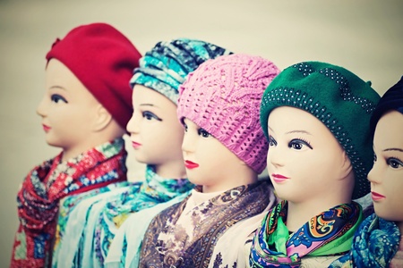the digital photo with a retro effect, female dummies of the heads for advertizing of headdresses, woolen knitted caps and silk scarvesの写真素材