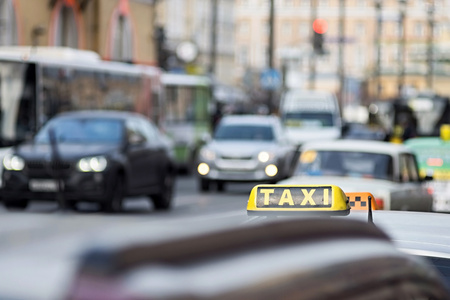 taxi on city streets on an indistinct background of other cars and vehiclesの写真素材