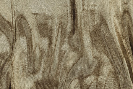 textured background fabric with abstract wavy stains of pale brown color for empty and pure...