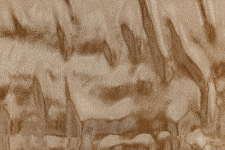 textured background fabric with abstract stains of pale brown color for empty and pure backgrounds