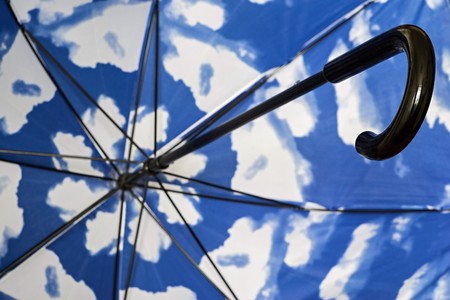 abstract fragment of an umbrella cane from within closeup with a spotty surface of blue white colorの写真素材