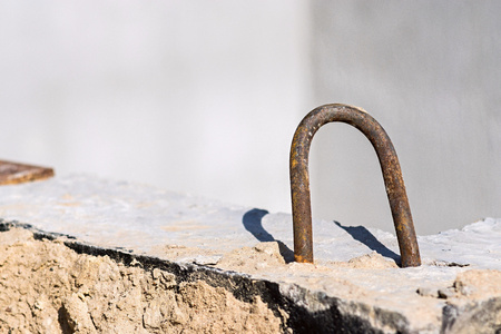 old rusty iron bracket closeup for assembly of a construction concrete designの写真素材