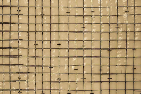 the textured abstract background of the reinforced lattice from steel cores of corrugated fittings