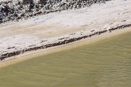 the sandpit for road construction is filled partially with rainfall of a rain and underground ground...