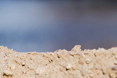 yellow sand under an indistinct blue background for the image of abstractions in the natureの写真素材