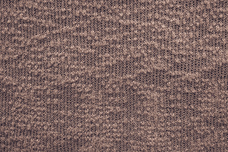 abstract knitted texture of dark terracotta color closeup for backgrounds with a blank space for the textの写真素材