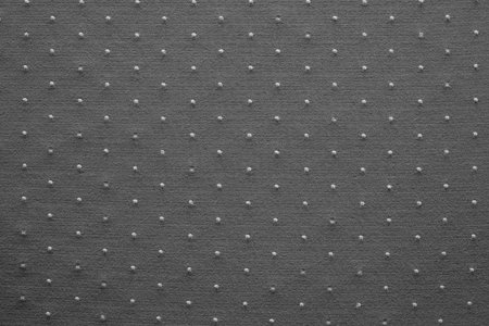 thin texture of knitted fabric of black color with small blond specks for abstract backgroundsの写真素材