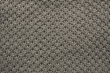 abstract knitted honeycomb texture of dark beige color from synthetic threads for backgrounds and for wallpaperの写真素材